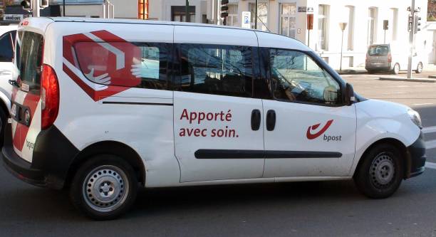 View Of Building Exterior, Advertisement Sign, Belgium Post Delivery Land Vehicle On The Road During The Day In Brussels Belgium Western Europe