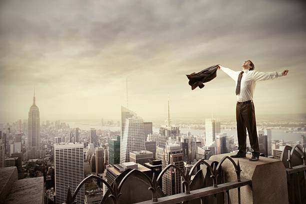 istock Businessman arms spread on rooftop with skyscraper 119850761