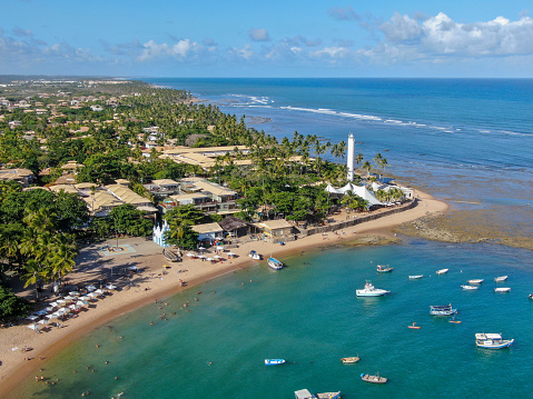 Aerial view of Praia Do Forte coastline village with beach and blue clear sea water, Bahia, Brazil. Travel tropical destination.