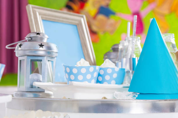 Beautiful birthday children sweet table with cupcake and decoration. Desk with sweet birthday party decoration indoor at a restaurant. Close up, selective focus. Birthday party decoration concept