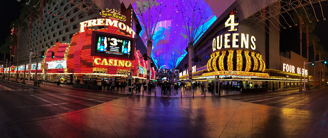 Las Vegas, USA: In old Las Vegas, panoramic view of the Fremont and 4 Queens Hotels and casinos situated on the famous Fremont street. The colorful ceiling of the Fremont Experience also appears in background. People are visible in the image.