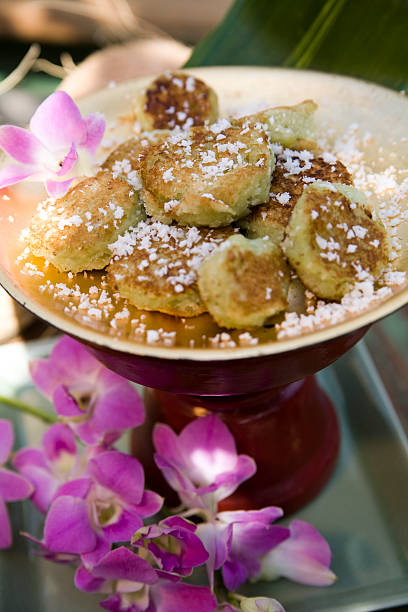 Thai Coconut Cookies with a Spray of Magenta Orchids stock photo