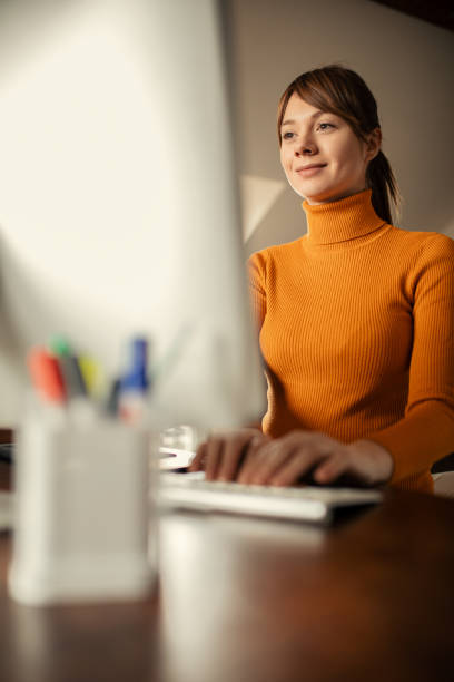 istock Young pregnant woman working on computer at home 1198521281