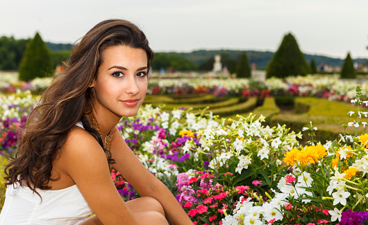 Beautiful young woman enjoying the gardens in a Parisian park.