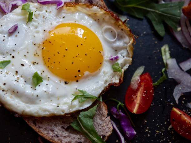 istock A good food, fried eggs with bread slices, vegetables and bacon rolls. 1198526358