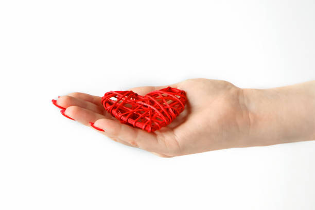 istock Red heart in the palm on a white background. 1198526515