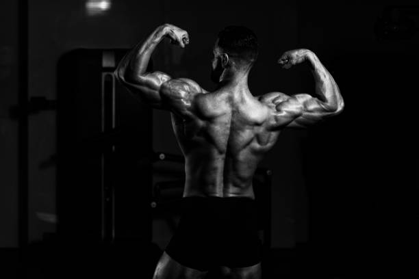 istock Handsome Muscular Man Flexing Muscles In Gym 1198532520