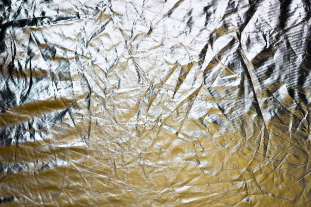 istock Silver and bronze foil reflector. Selective focus. Creative vintage background. 1198532827