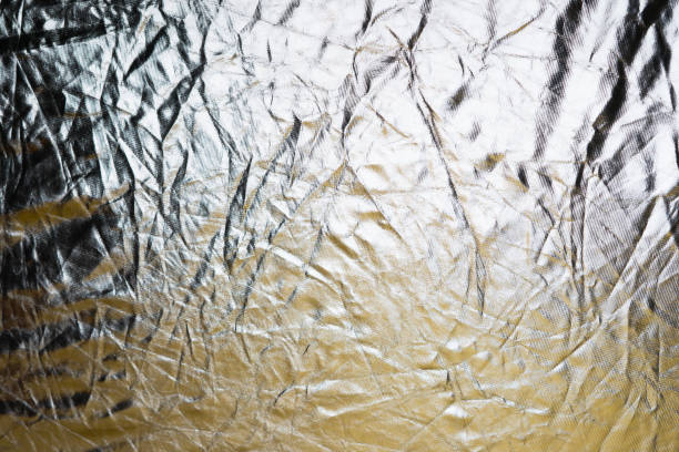 istock Silver and bronze foil reflector. Selective focus. Creative vintage background. 1198532828