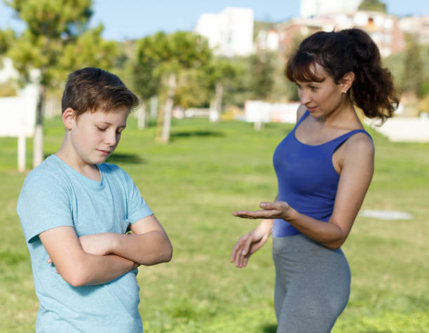 istock Mother berating son outdoors 1198533734