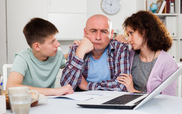 istock Chagrined family analyzing finances 1198533836