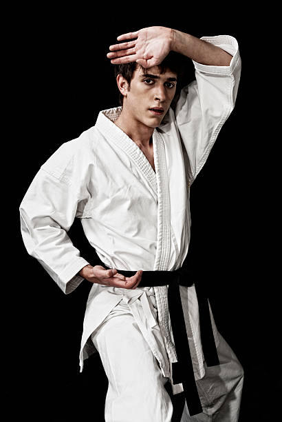 istock Karate male fighter young high contrast on black background. 119853724