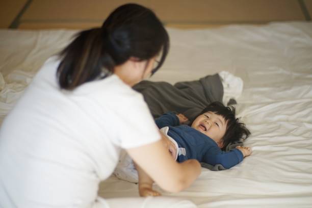istock Mother changing baby boy's diaper 1198537845