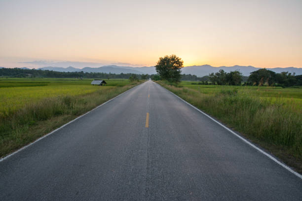 istock Asphalt road with Mountain at sunset 1198541808