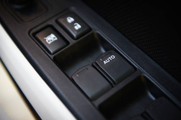 istock Car interior on the doors inside car door handle with power window control unit / 1198542984