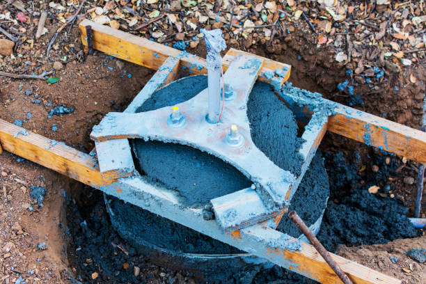 istock Street light base foundation installation. Excavated area. Wood stakes secure foundation assembly upright. Parking lot or road infrastructure improvement or repair 1198545462
