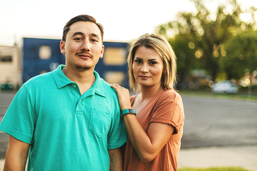 In Western Colorado Beautiful Millennial Couple posing for portrait (Shot with Canon 5DS 50.6mp photos professionally retouched - Lightroom / Photoshop - original size 5792 x 8688 downsampled as needed for clarity and select focus used for dramatic effect)