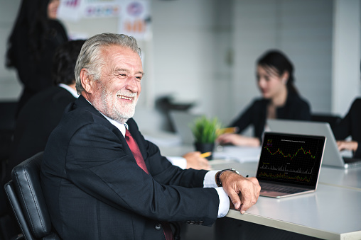 Mature Businessman Smiling to Working with Business People Teamwork in an Office - Corporate Concept
