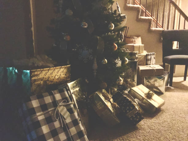 istock Christmas tree with many wrapped gifts underneath 1198554115