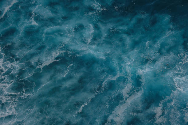 istock Aerial view to ocean waves. Blue water background. 1198555413