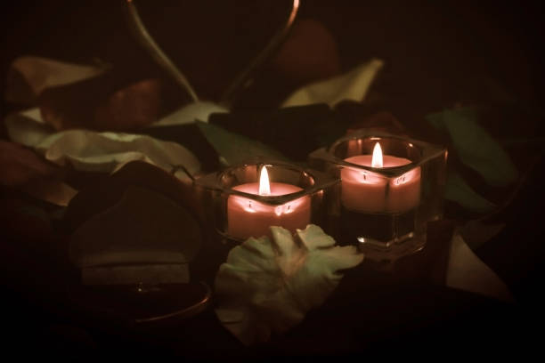 istock two candles on the dark festive table 1198558659