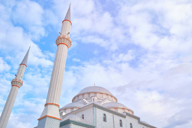 istock Minarets of a mosque opposite cloudy blue sky 1198560488
