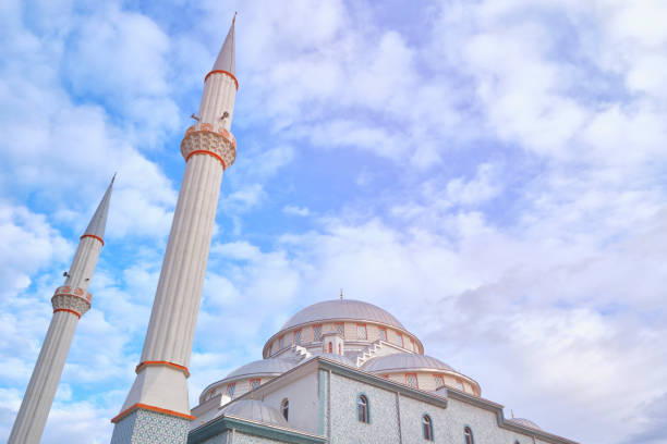 istock Minarets of a mosque opposite cloudy blue sky 1198560490