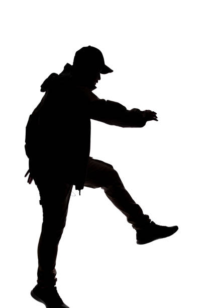 istock Silhouette of a Male Hiker or Explorer Jumping or Leaping 1198562506