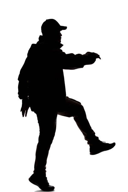 istock Silhouette of a Male Hiker or Explorer Jumping or Leaping 1198562509