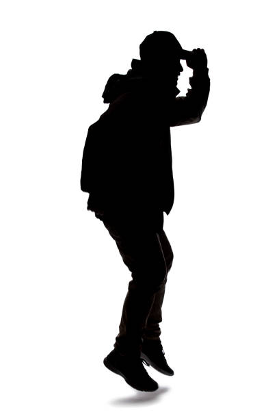 istock Silhouette of a Male Hiker or Explorer Jumping or Leaping 1198562530