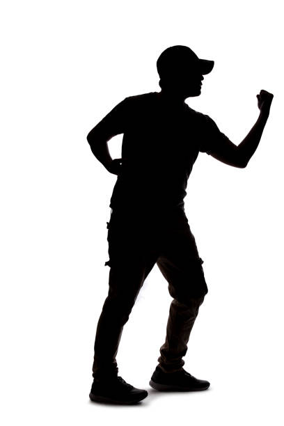 istock Silhouette of a Male Figure on a White Background Punching Something 1198562556