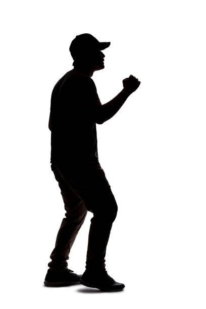 Silhouette of a man wearing casual clothes isolated on a white background. He is punching and hitting something