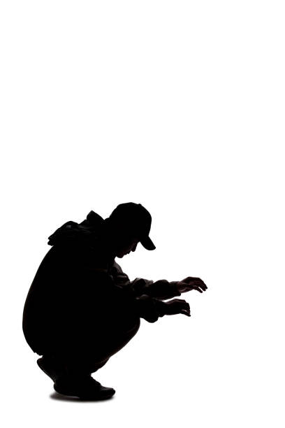 Full length profile shot of a security officer with a walkie talkie chasing a burgler isolated on white background