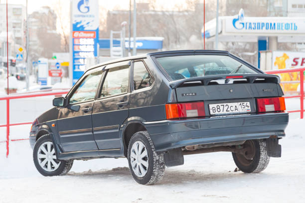 Novosibirsk, Russia - 12.27.2019: Green lada 2114 year front view with dark gray interior in excellent condition in a parking space among other cars