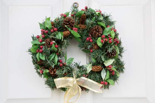 istock Festive Christmas Wreath on White Front Door 1198570807
