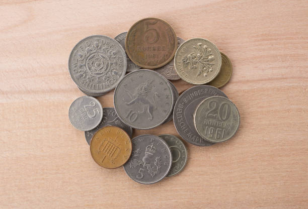 istock stack of old coins on wooden background. 1198572898