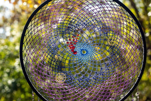 istock Handmade dream catcher with feathers threads and beads rope hanging 1198576430