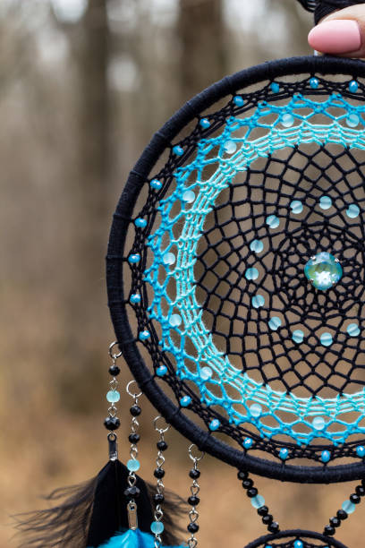 istock Handmade dream catcher with feathers threads and beads rope hanging 1198576512