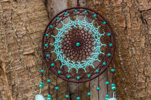 istock Handmade dream catcher with feathers threads and beads rope hanging 1198576545