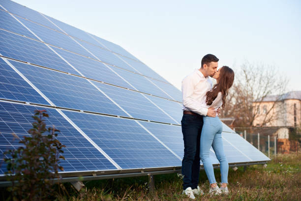 istock Kissing couple near solar panel 1198580080