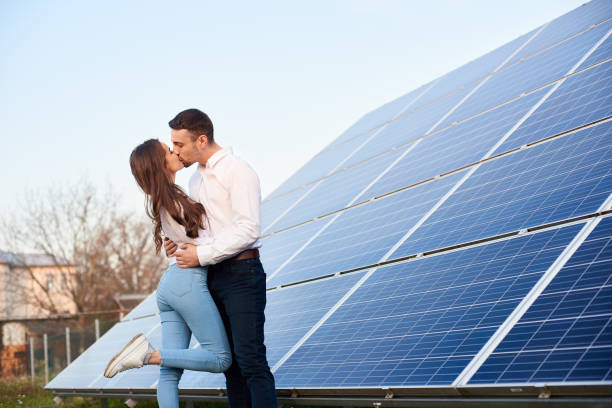 istock Kissing couple near solar panel 1198580102