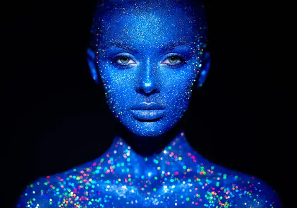 Photo of Portrait of beautiful woman with sparkles on her face