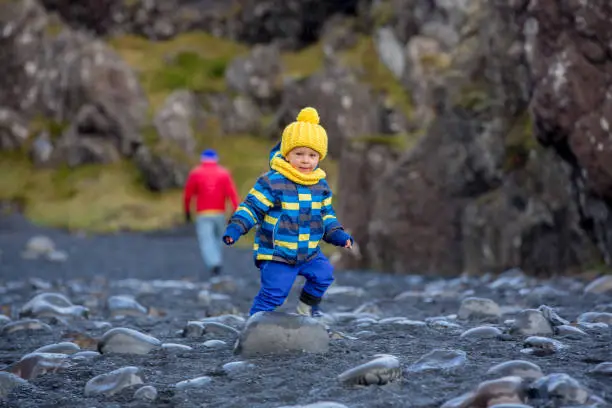 Photo of Child, walking on the beach in beautiful nature in Snaefellsjokull National Park in Iceland