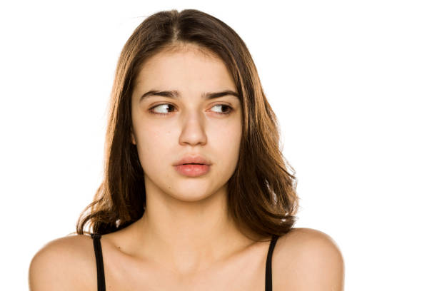 istock Young beautiful woman without makeup looking aside on white background 1198585505