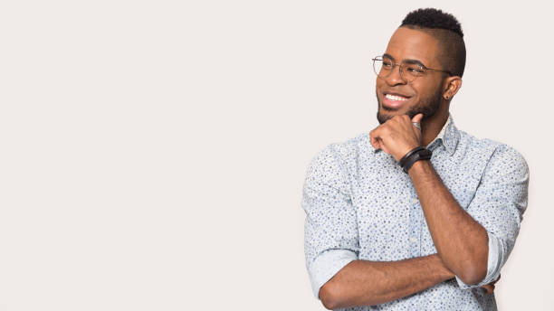 istock Smiling african American man look at blank copy space 1198585611
