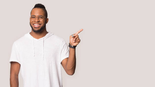 istock Smiling biracial man in glasses point at blank copy space 1198585643