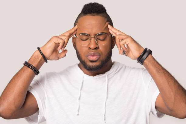 istock Exhausted biracial man breathing suffering from headache 1198585651