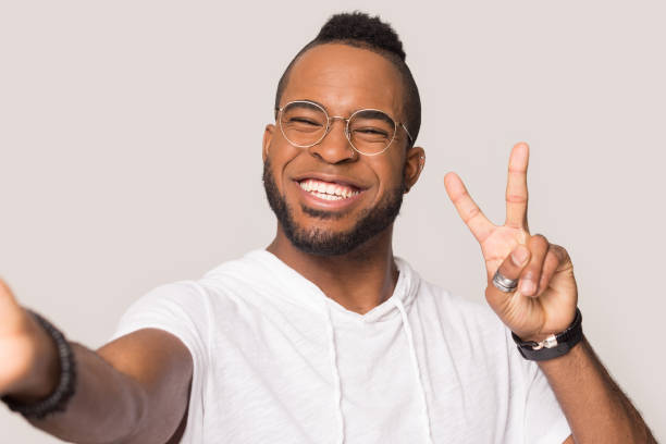 Happy african American man smiling posing for selfie
