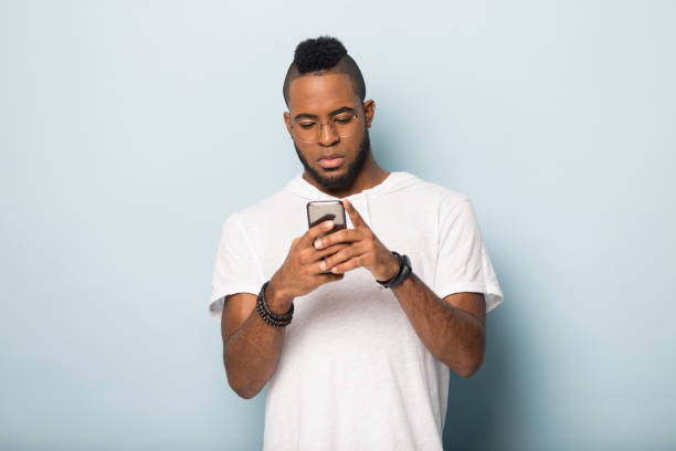 istock Serious biracial man in glasses using modern smartphone 1198585656