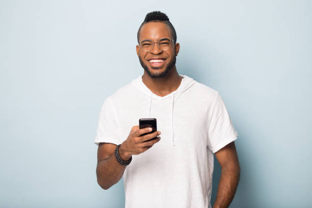 istock Overjoyed african American male client using modern cellphone 1198585661